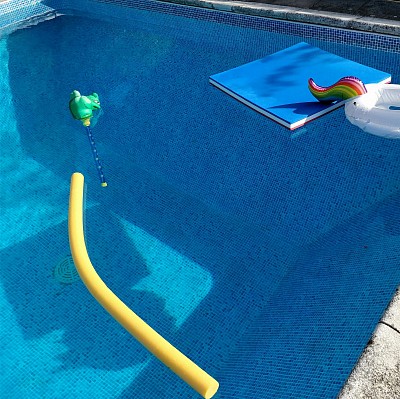 Clean pool with pool toys and floats